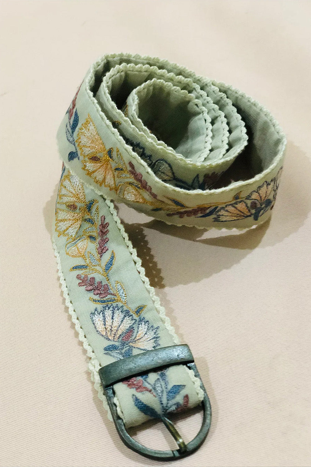 Green floral embroidered belt.