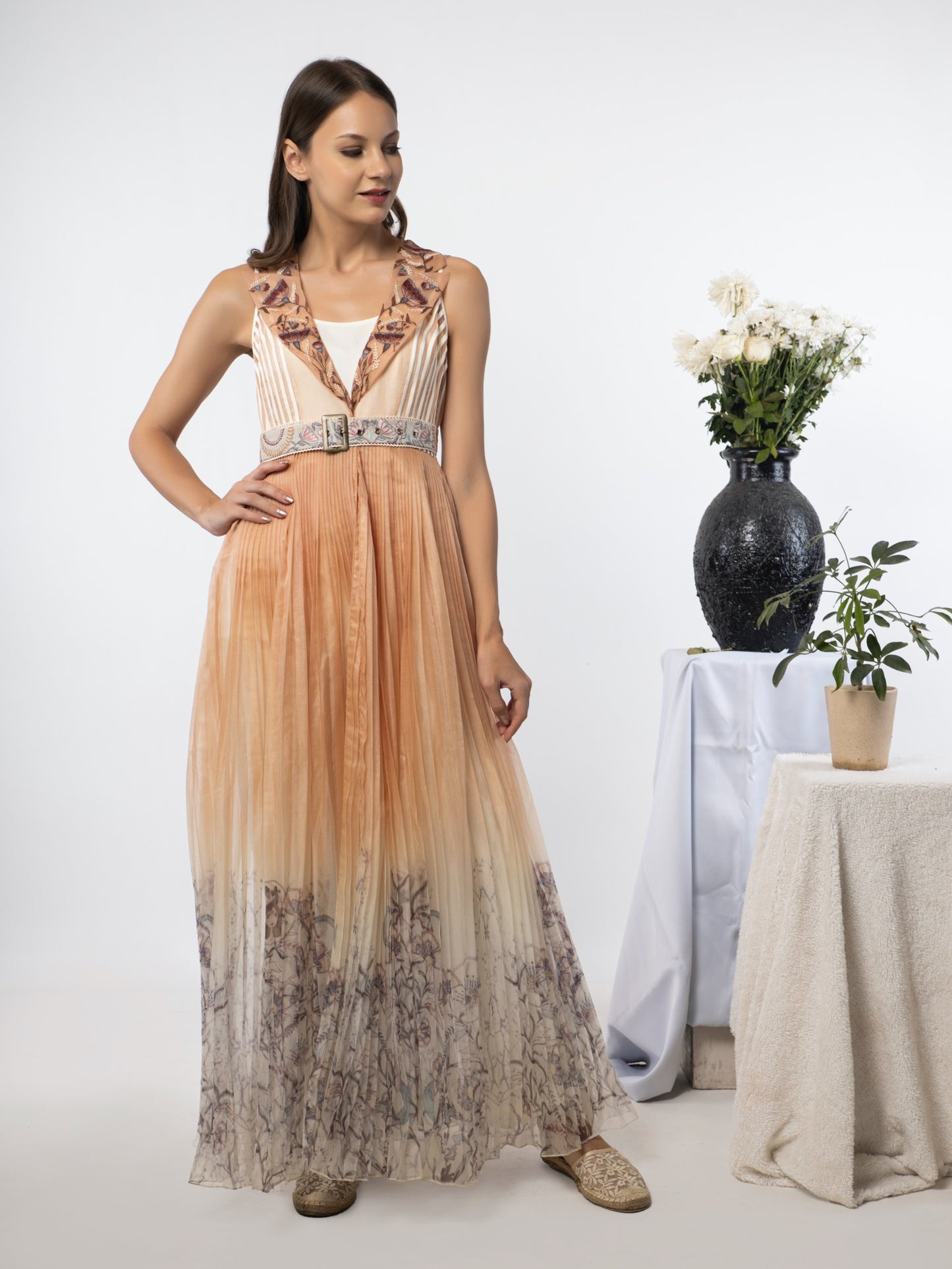White jumpsuit with a sand-peach cape. image 1