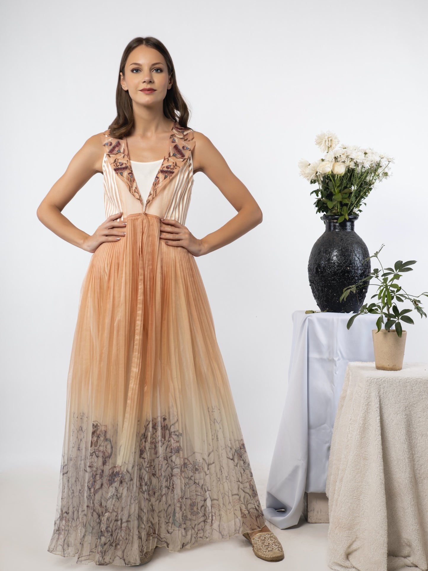 White jumpsuit with a sand-peach cape. image 2