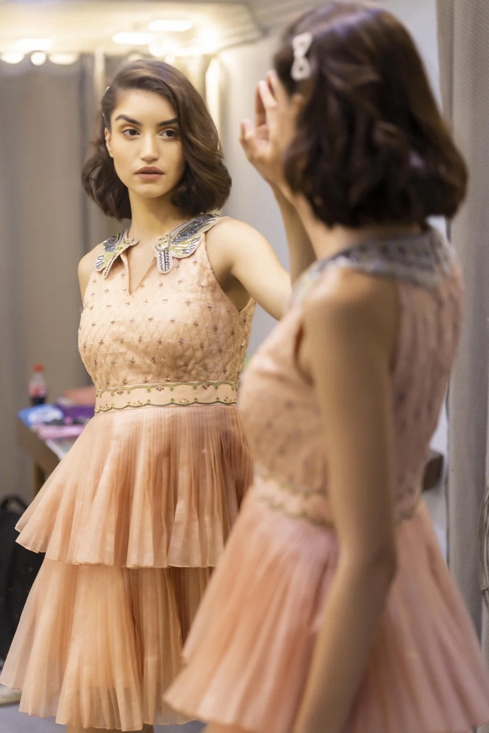 Embroidered pleated knee length collar dress.