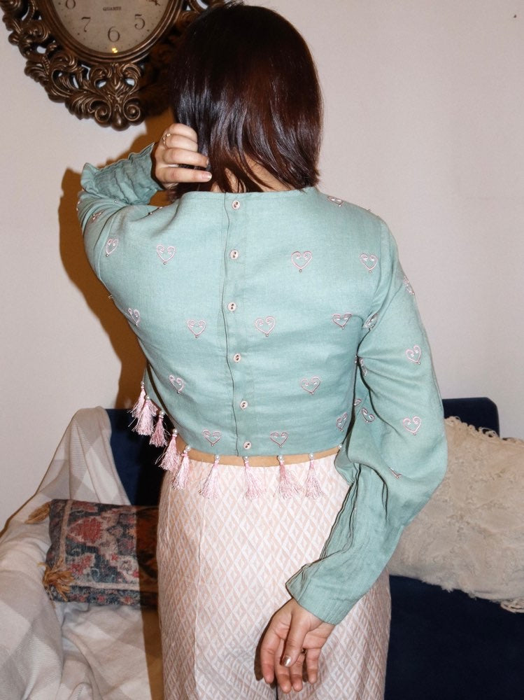 Sage green crop top paired with textured pants image 3