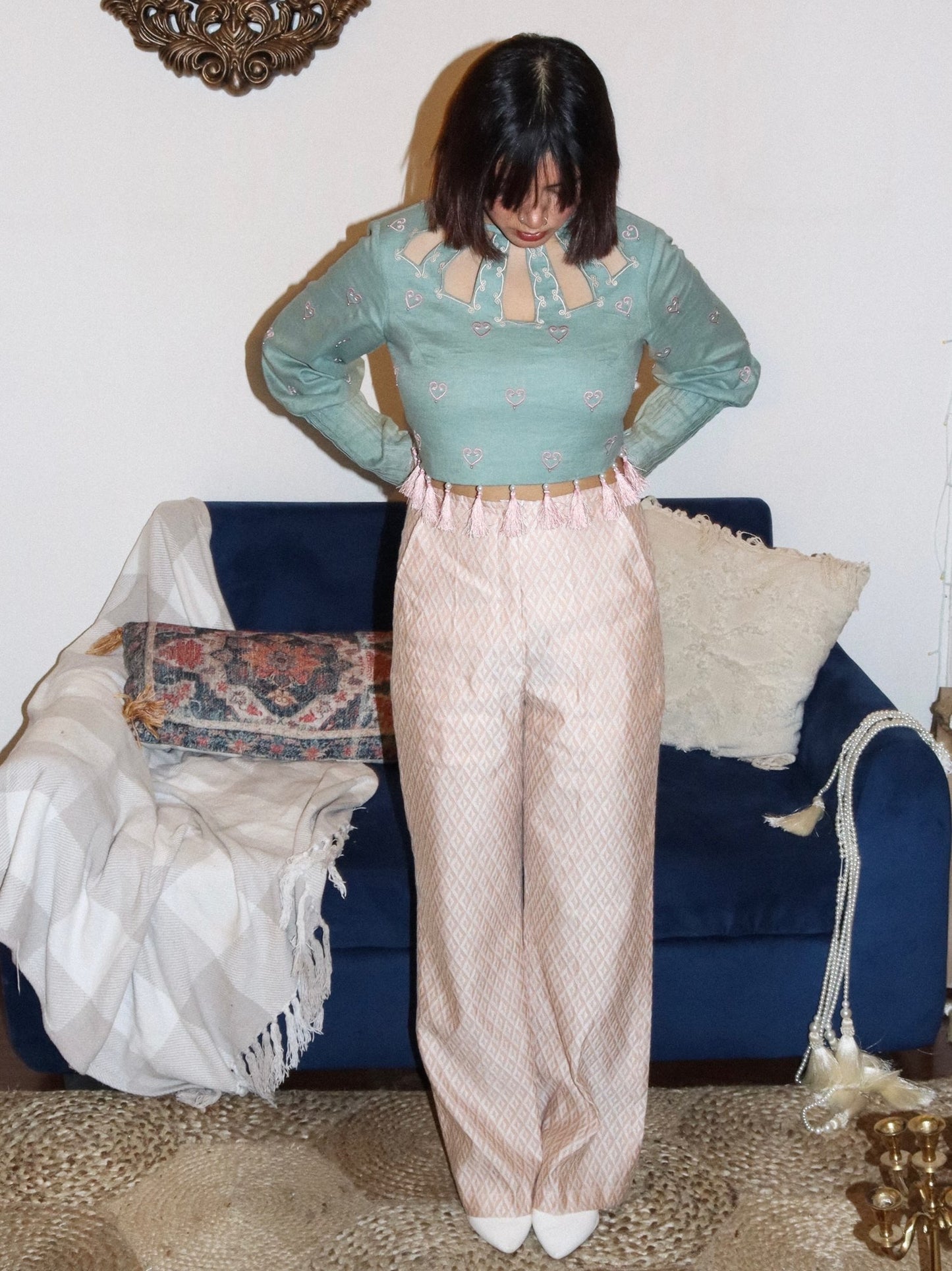 Sage green crop top paired with textured pants image 1