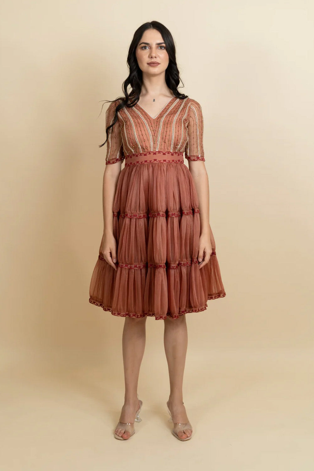 Golden galaxy cinnamon embroidery in narrow pleated dress.
