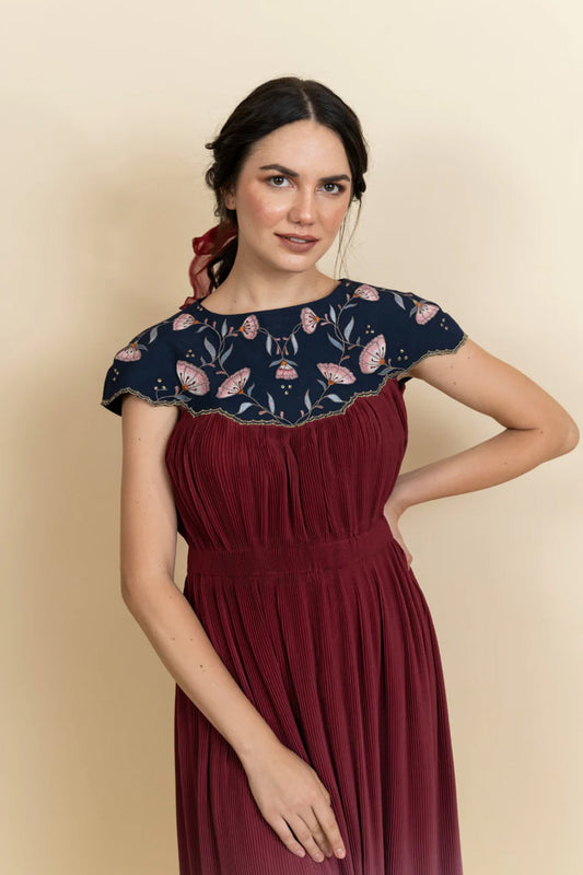 Floral embroidered neckline in a full length dress. (Blue)